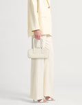 Structured baguette bag in grained leather